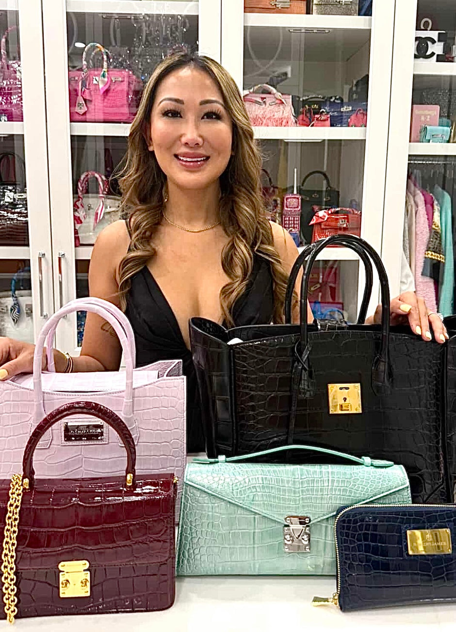 Woman holding and displaying various handbags in a store setting